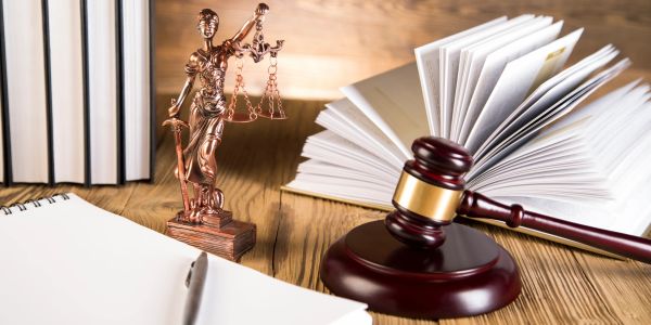 Law books, a gavel and scales of justice